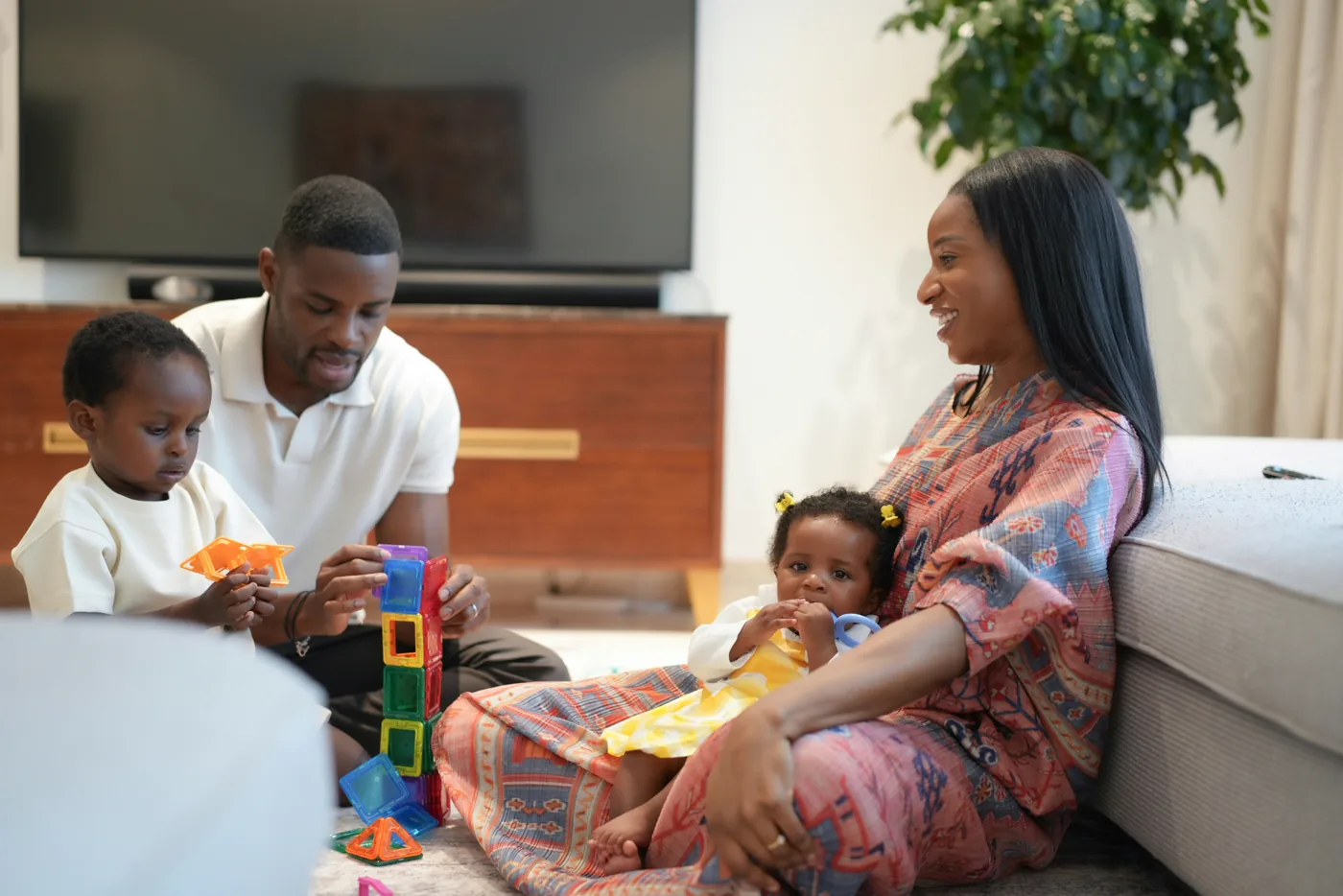 Parents and their children playing together at home.