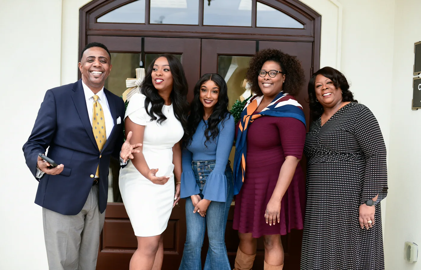 A family dressed up and smiling together.