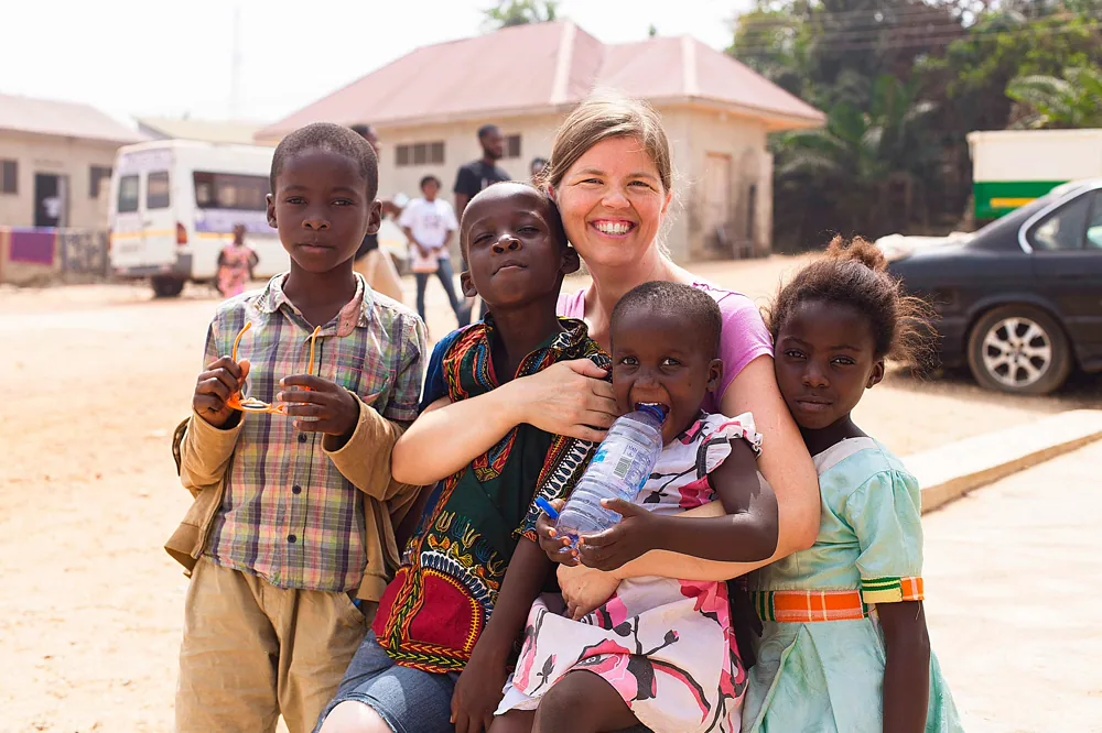 A caregiver with children in the community.