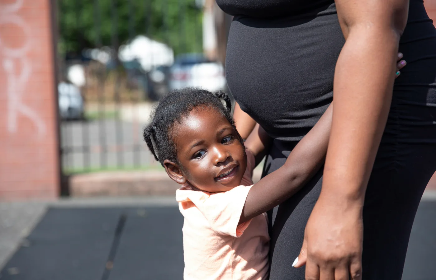 A mother holding her young child close.