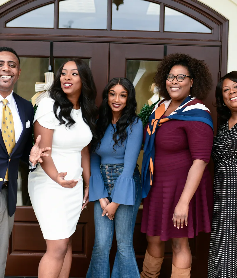 A family dressed up and smiling together.